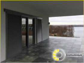 Automatic aluminium sliding shutters in the cottage side view